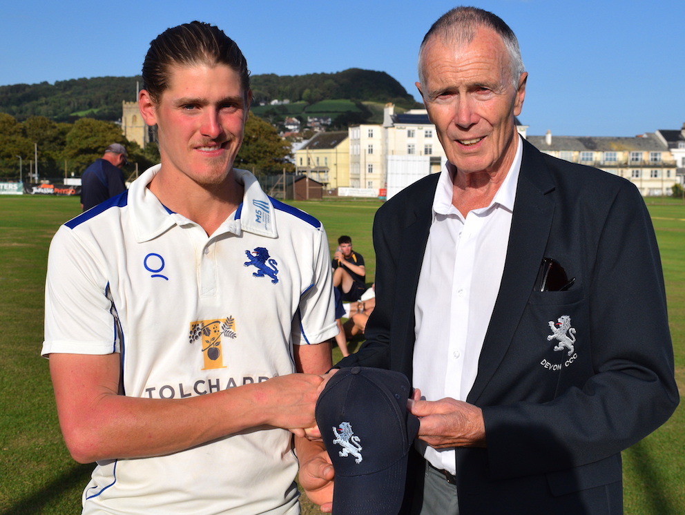 Devon president Jack Davey hands Elliot Hamilton his county cap during the game against Herefordshire at Sidmouth