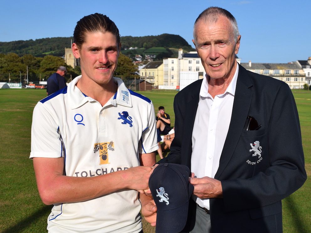 Plympton batsman Elliot Hamilton receiving his Devon cap from county president Jack Davey