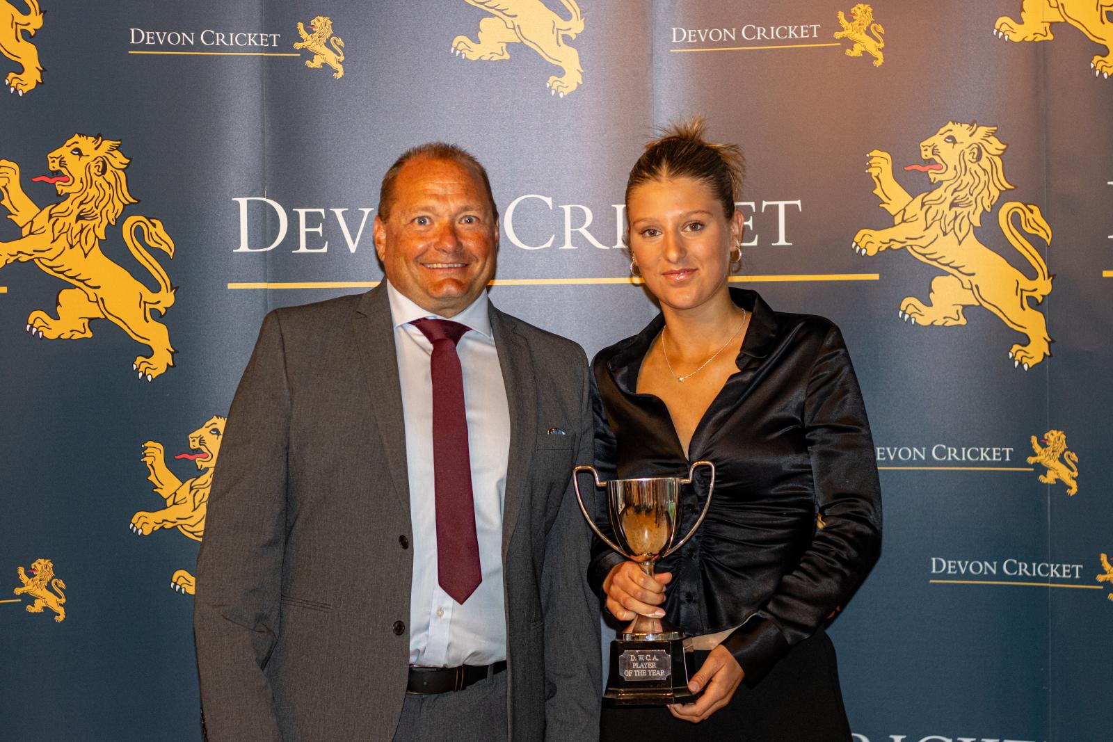Erin Vukusic is presented with the Devon Women Player of the Year award by Trevor Griffin.
