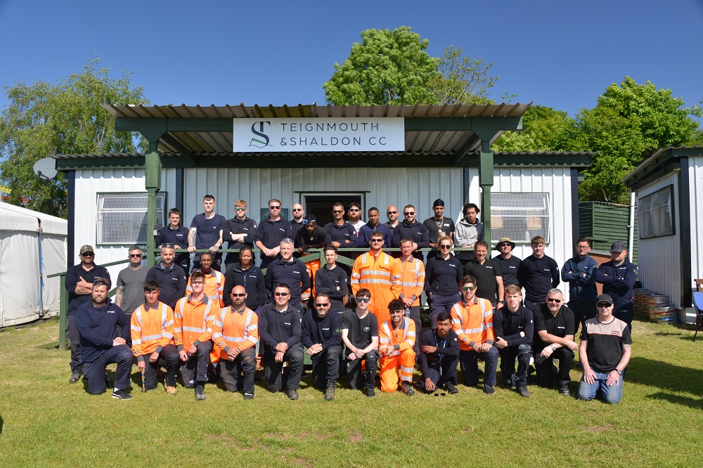The National Grid apprentices pose in front of the revamped clubhouse at Hazeldown Oval.