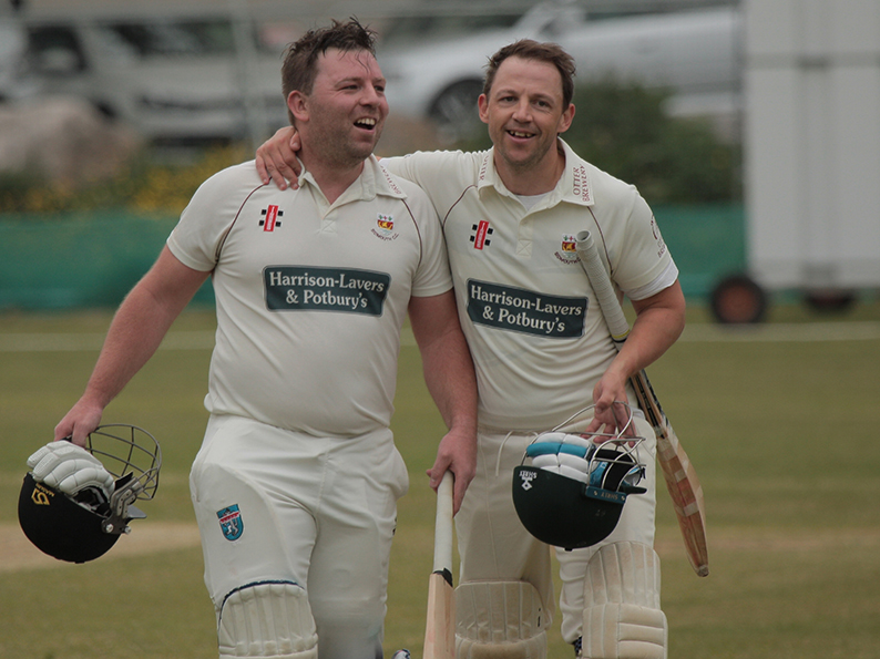 Sidmouth century maker Matt Cooke (left) makes his way off the field with skipper Nick Gingell after reaching his ton with a single off the final ball of his side's inning<br>credit: Al Stewart