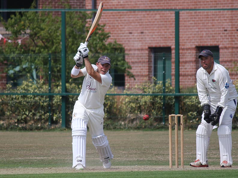 Rob Holman cracks the ball through the covers batting for Exeter against Exmouth last season<br>credit: Gerry Hunt
