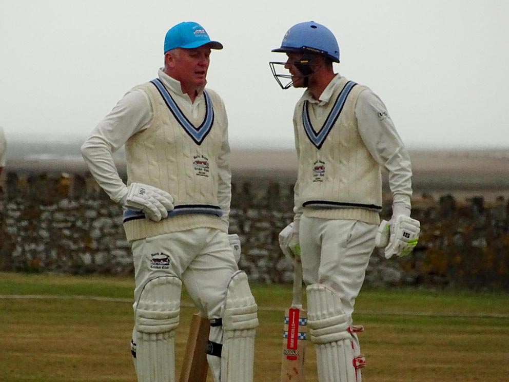 North Devon batsmen Rob Ayre (left) and Jack Hockin talk tactics during a break in play in the game against Bradninch Photo: Fiona Tyson