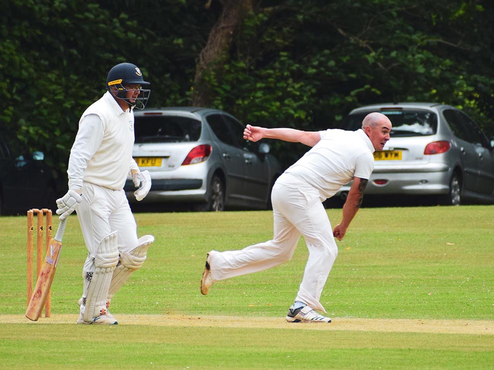 Bridestowe's Gary Sizmur on the way to a four-wicket haul against Bideford. The batsman is James Ford<br>credit: Katie Jecks