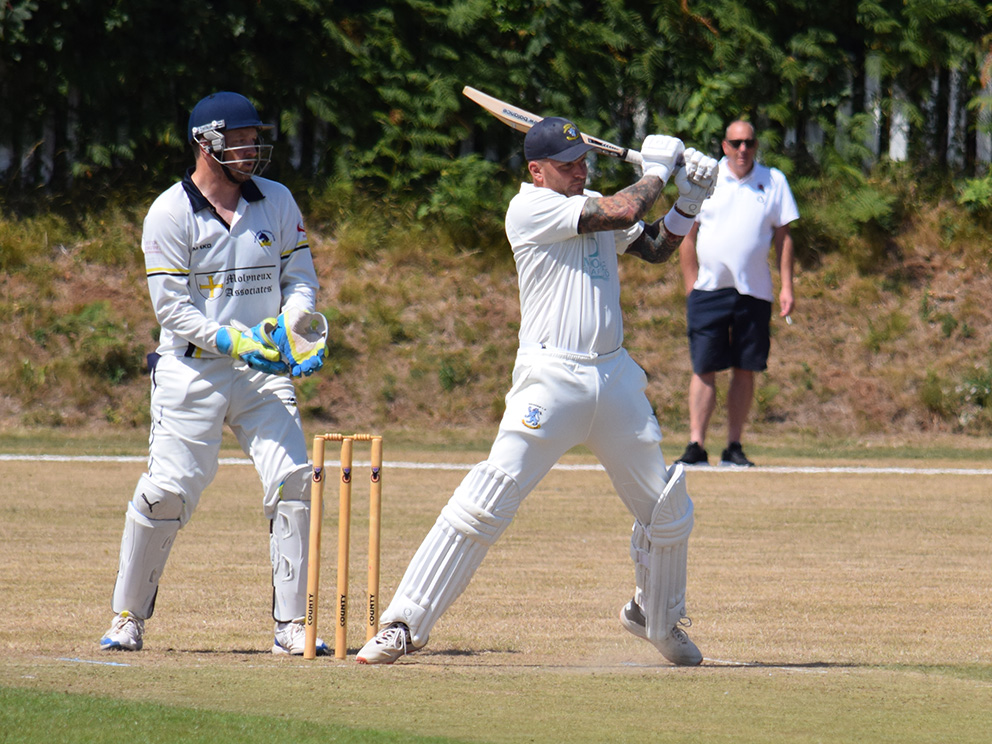 GO FETCH! Brixham's Chris Lanyon hits out on the way making 35 in the D West win over Plymstock. Watching from the boundary is Lanyon's dad Terry<br>credit: Conrad Sutcliffe - no re-use without copyright owner's consente