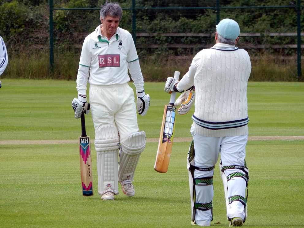 Changing of the guard. Outgoing chairman Derrick Foan (left) makes his way off as Chris Dean (right) makes his way to the crease <br>credit: Contributed