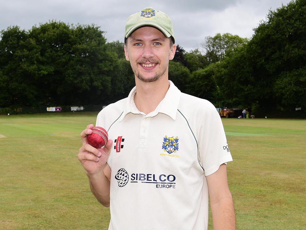Bovey Tracey pace bowler Hugo Whitlock with the match ball as a memento after performing two hat-tricks in his side's win at Cullompton<br>credit: @ppauk