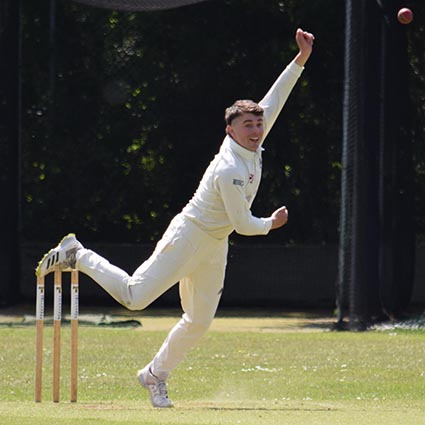 Bovey's Will Christophers bowling against Heathcoat
