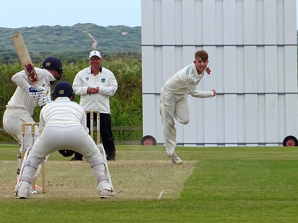 North Devon's Jack Moore on the way to a five-wicket haul against Budleigh Salterton<br>credit: Fiona Tyson