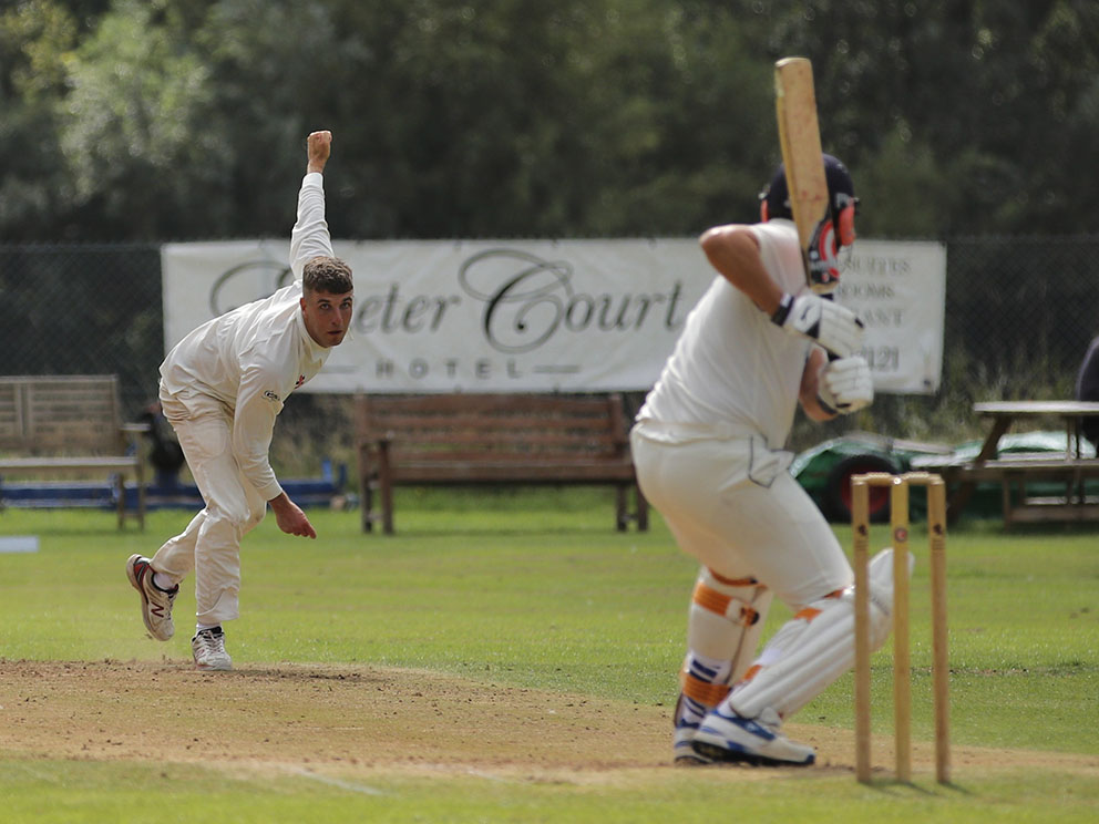 Kenn's Hugh Stronge bowling against PCS&R in the win that sealed promotion for his side | Al Stewart<br>credit: Al Stewart