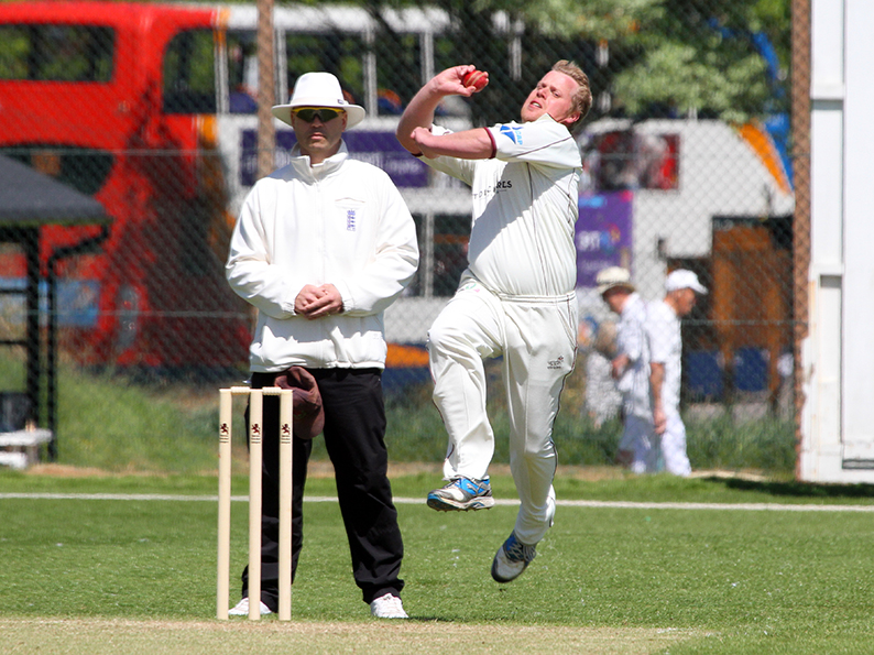 Trevor Anning runs past umpire Steve Lavis during a game at Sidmouth