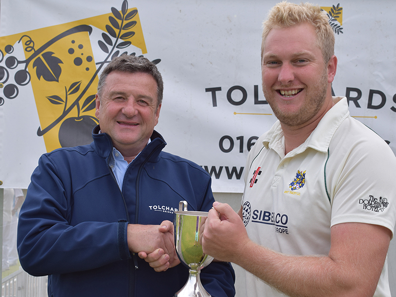 Jim Mardell of Tolchards hands the DCL Premier trophy over to Bovey Tracey's Pete Bradley
