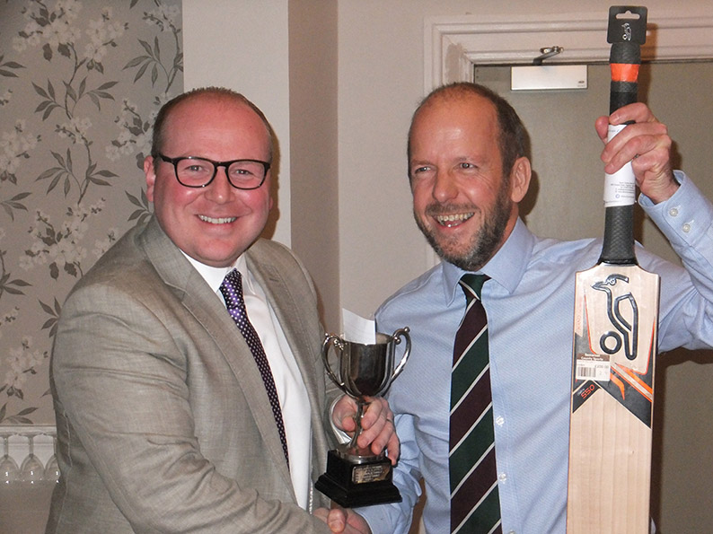 Bobby Marshall of Sidmouth CC sponsors Harrison Lavers & Potburys presents the raffle-prize bat to Charlie Dibble