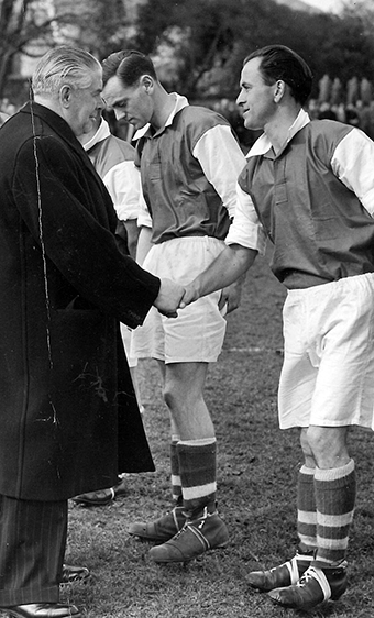 Danny Hughes the Kingsteignton footballer being introduced to a VIP guest before the 1953 Herald Cup final