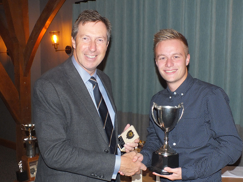 South Devon CC president Chris Hart hands over the bowler of the year trophy to 1st XI captain James Allen