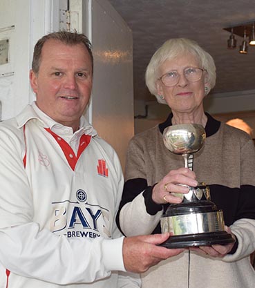 Cup winning captain Terry Farkins collects the trophy from Angela Glendenning, a Brockman family member