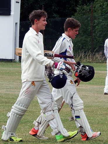 Sonny Baker (left) and Elliot Hamilton make their way off after steering Devon to victory