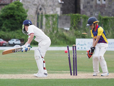 A wicket falls during Exeter's win at South Wilts in the regional festival final