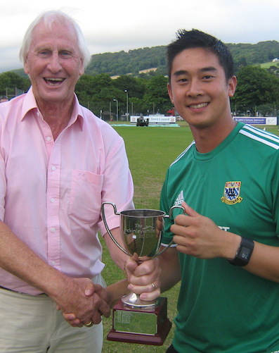 DCL chairmam Stuart Munday hands the Devon T20 Cup to Torquay captain Justin Yau