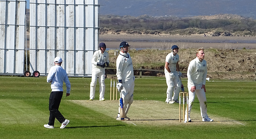 North Devon bowler Ben Howe waits for the ball to be returned. The batsman at the non-striker's end is Liam Lewis 