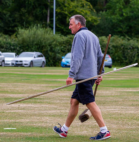 Bovey Tracey's hard-working chairman Nigel Mountford going out to re-mark the pitch during a tea interval | Mark Lockett