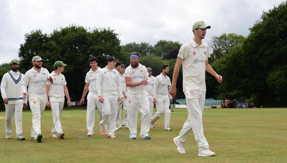 Bovey Tracey's Hugo Whitlock leads the team off after taking seven wickets against Cullompton | @ppauk
