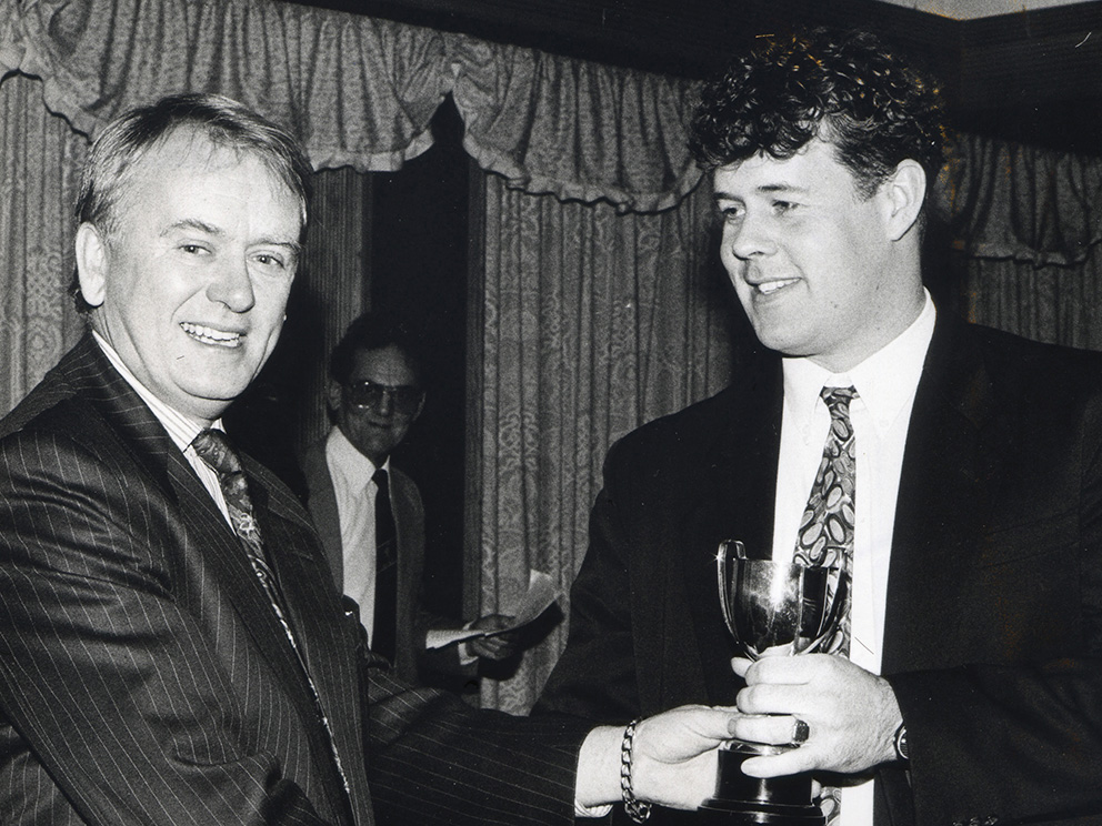 Joe Clowes presenting Alphington's Andy Mills with a league trophy during the 1993 awards evening held at the Langstone Cliff Hotel in Dawlish. In the shadows behind Joe is Graham Shears, who was league chairman at the time<br>credit: Contributed