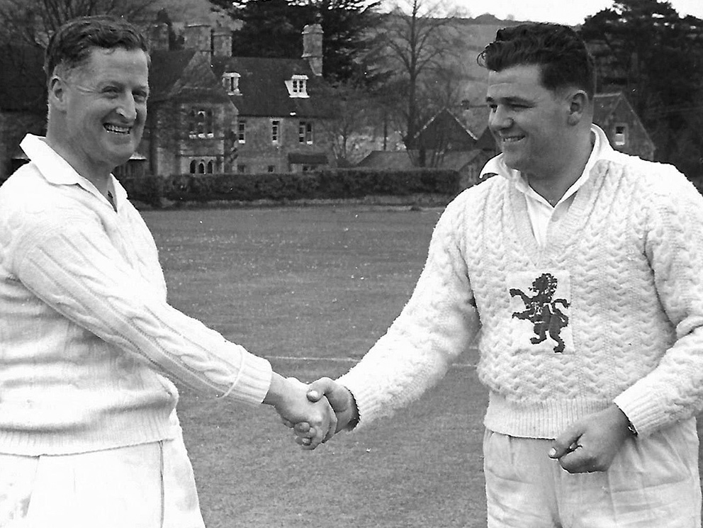 Stuart Mountford (right) sporting his unique Devon sweater, shakes hands with Alphington captain Gerry Gilpin before a match at Bovey Tracey<br>credit: Mountford Family Album