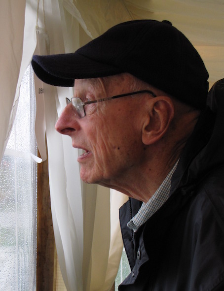 John Phillips peering through the pavilion window at Instow during a rain break