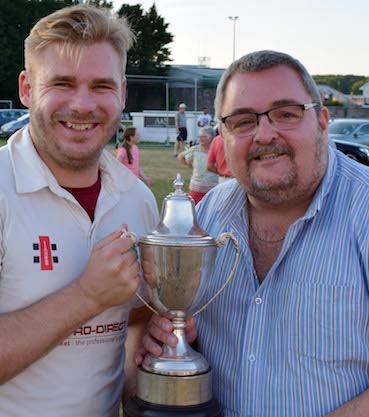 Winning captain Stuart Bowker receives the cup from sponsor Marcel Massey of Aaron Printers