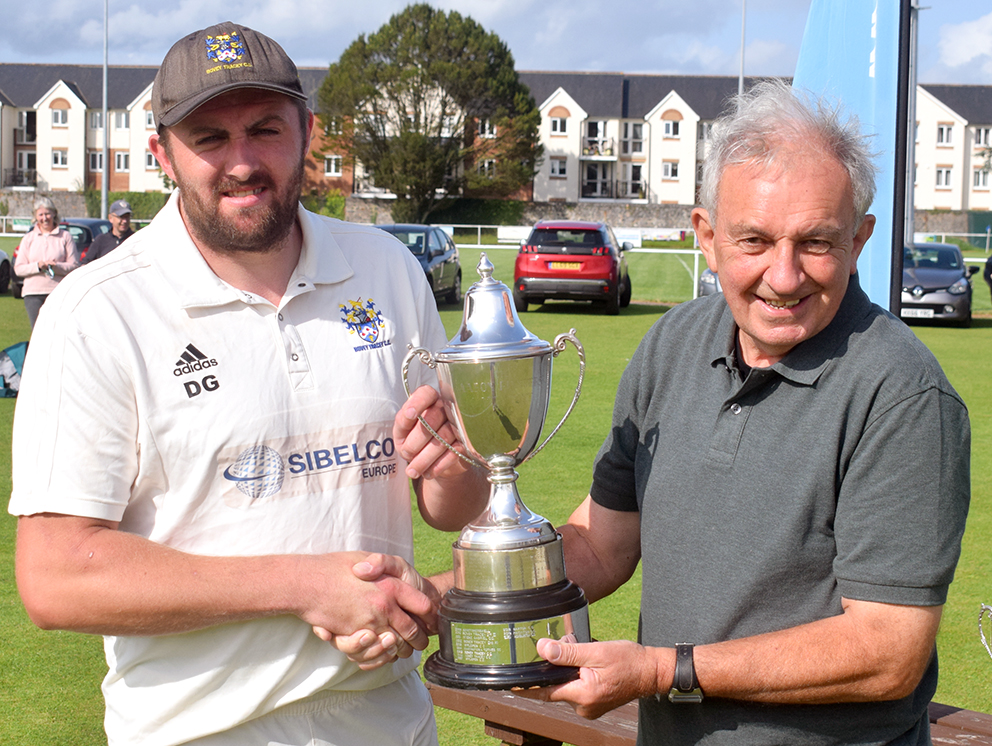Bovey Tracey captain Dan Green (left) collects the Aaron Printers Cup from Barry Widdicombe, the vice-chairman of host club South Devon CC<br>credit: Conrad Sutcliffe - no re-use without copyright owner's consent