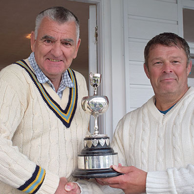 Nigel Mountford (Devon CCC) presents the Brockman Cup to winning captain Andy Williams