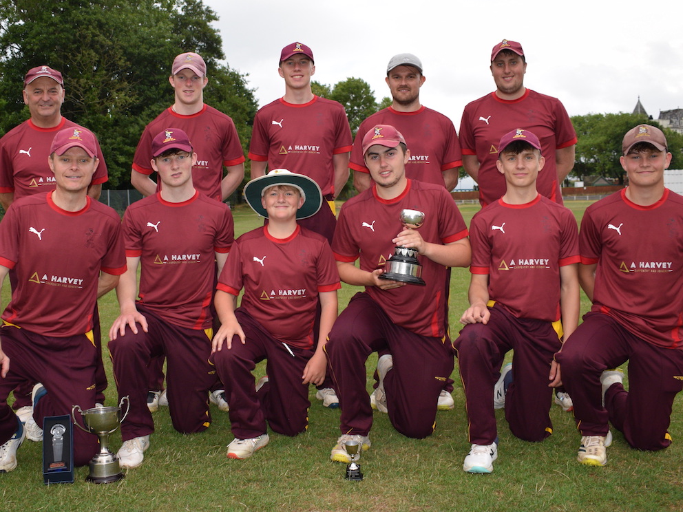 The Ipplepen cup winners pose on the outfield with the Brockman Cup after defeating Bovey Tracey in the final