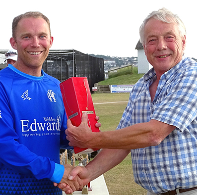 Man of the match Rob Holman collecting his award from Nick Rogers, the DCL chairman