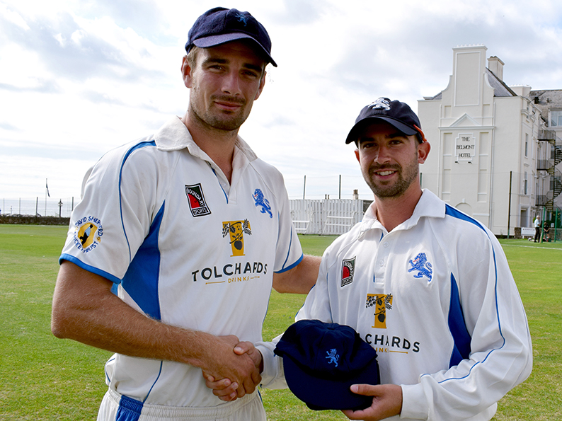 Well played - Devon skipper Josh Bess (left) presents Alex Barrow with his cap at the start of day of the game against Dorset at Sidmouth<br>credit: Conrad Sutcliffe