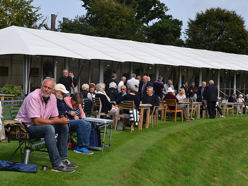 Spectators settle down for the day's play at Wormsley