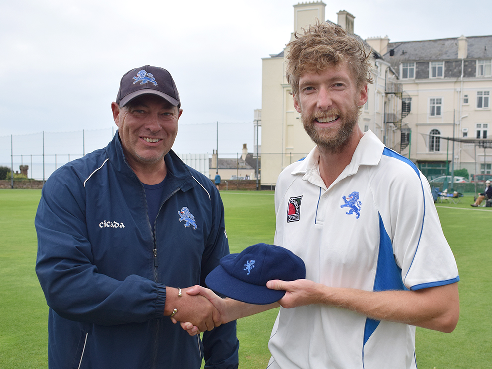 Dave Tall (left) presents Calum Haggett with his county cap during the game against Shropshire at Sidmouth in 2021. Haggett went on to make his maiden century for Devon later in the game<br>credit: Conrad Sutcliffe