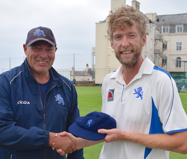 Dave Tall (left) presents Calum Haggett with his county cap during the lunch interval