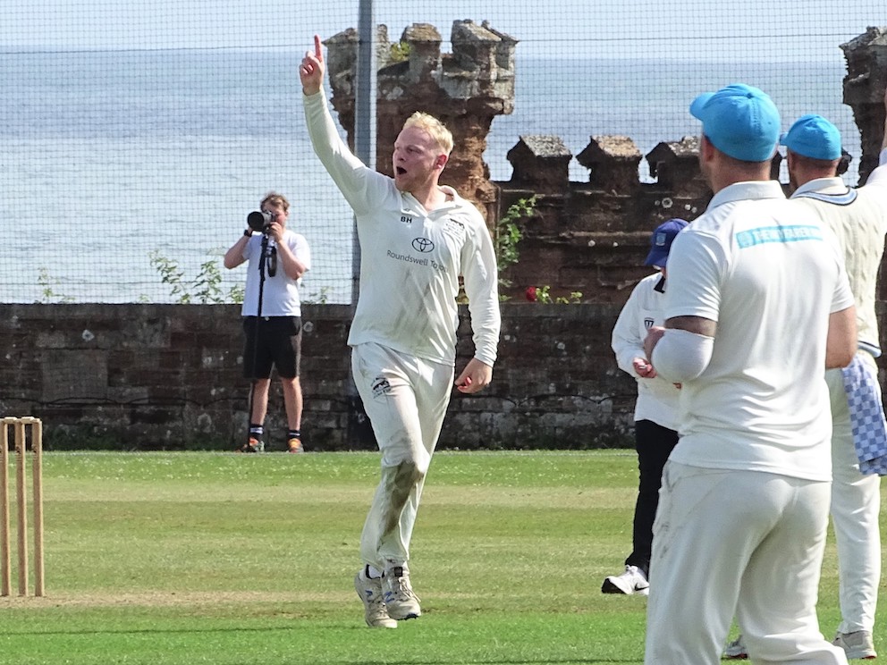 North Devon's Ben Howe celebrates taking one of his six wickets in the match