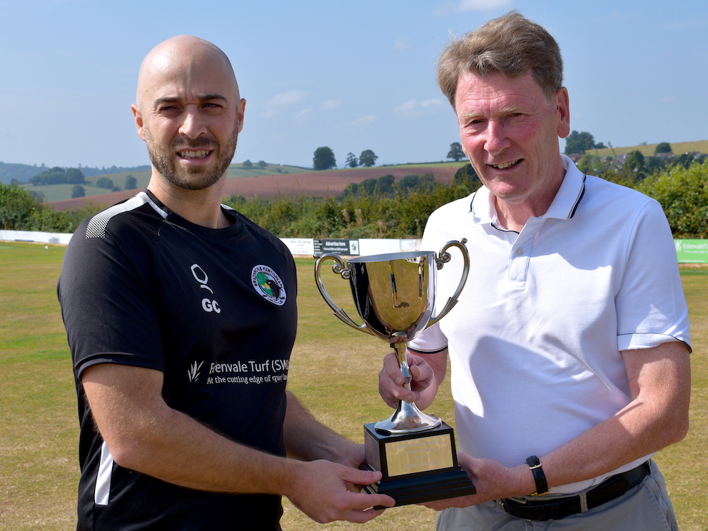 Just champion! Bradninch & Kentisbeare captain Gary Chappell (left) receiving the Tolchards DCL Premier Division winners' trophy from league rules and regulations officer Peter Avery prior to the game against Exeter at Kensham Park<br>credit: Conrad Sutcliffe - no re-use without copyright owner's consent