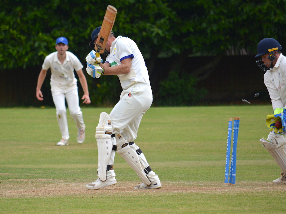 That's out! The bails fly as Braunton's Peter Needham is bowled by Ottery's Jodie Clements