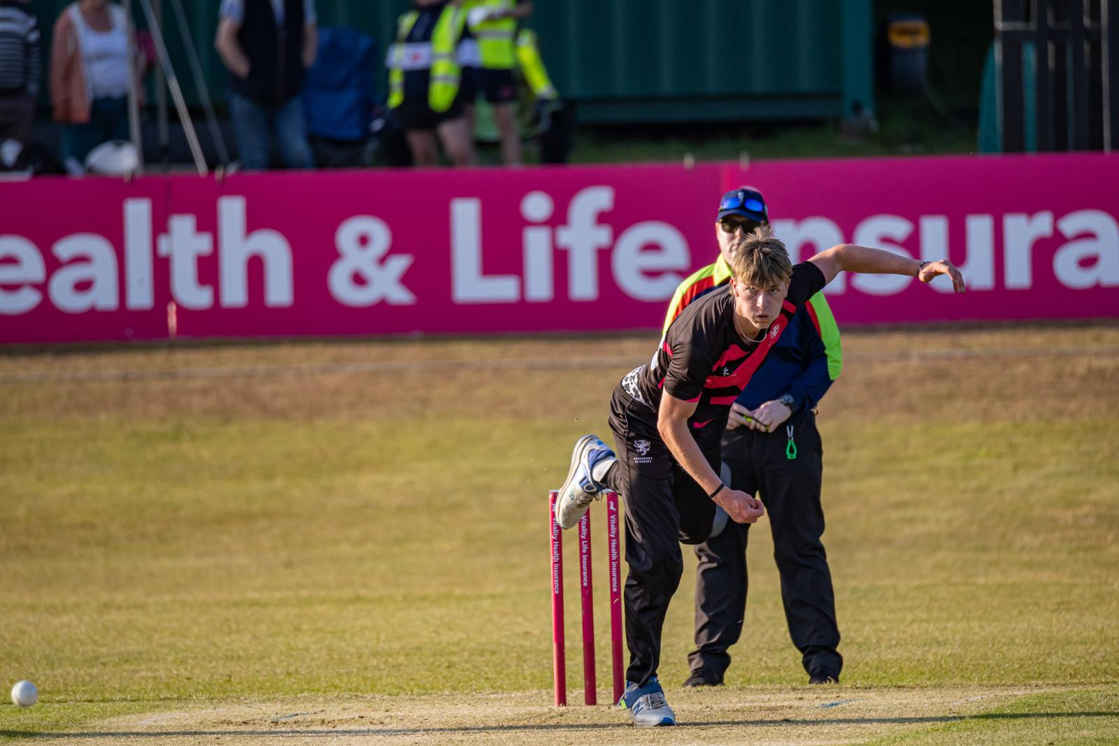 Zach Vukusic bowls from the pavilion end at The Maer for Somerset against Devon.