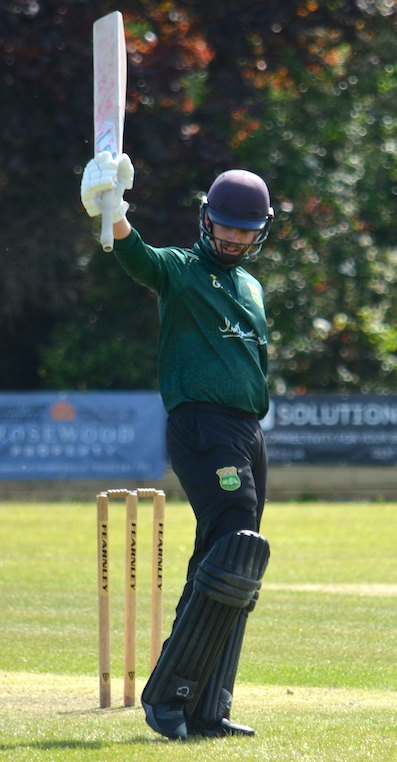 Cornwood's George Thompson raises his bat to acknowledge the applause for reaching 50 against Exeter
