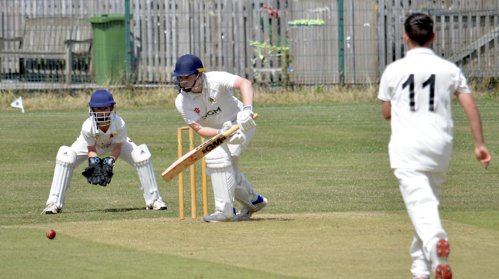 Abbotskerswell batter Max Yates keeps out a delivery from Paignton's Callum Knight, whose twin Harry is the wicketkeeper