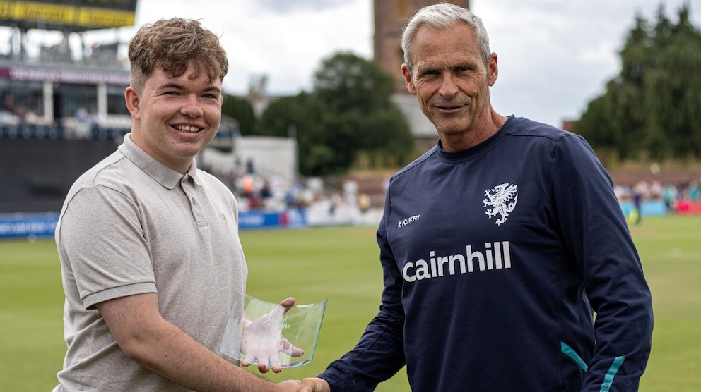 Cricket badger Ollie Smith receiving a volunteer award on the ground at Taunton from Andy Hurry Cricket badger Ollie Smith receiving a volunteer award on the ground at Taunton from Andy Hurry