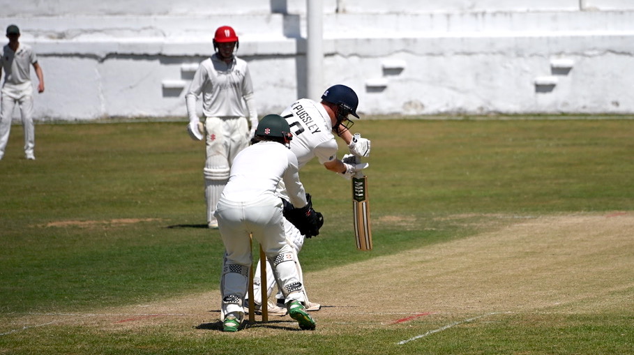 Heathcoat's Richard Pugsley plays forward to Hatherleigh's Charlie Presswell