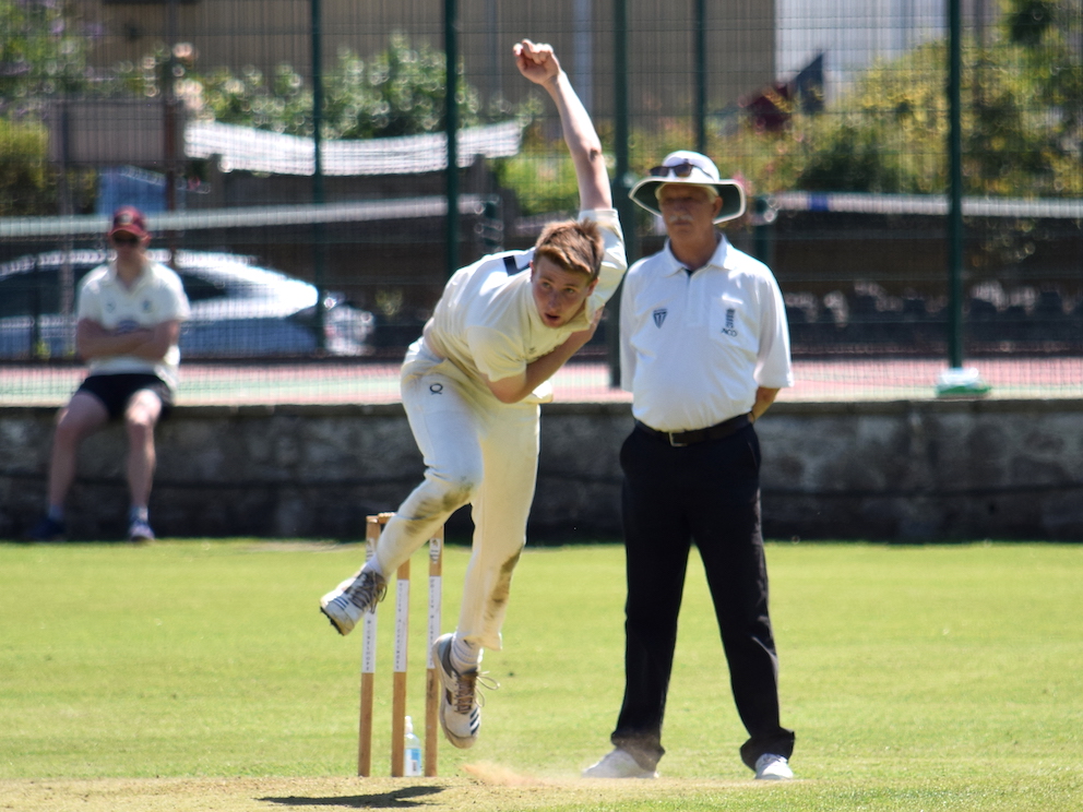 Archive photo of Paignton's Jack Harman bowling against Torquay in 2021 