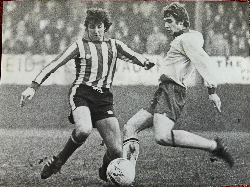 Graham Weeks (left) gets struck in playing for Exeter City