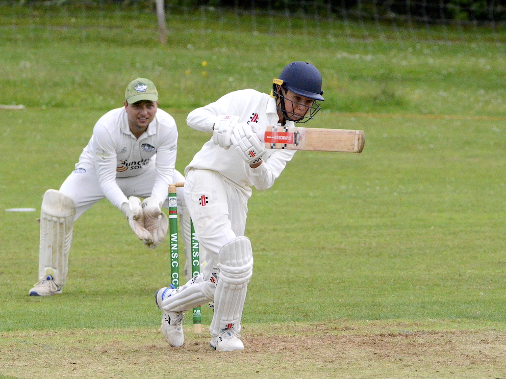 North Devon's youthful opener Freddie Bess drives the Woodbury & Newton St Cares bowling
