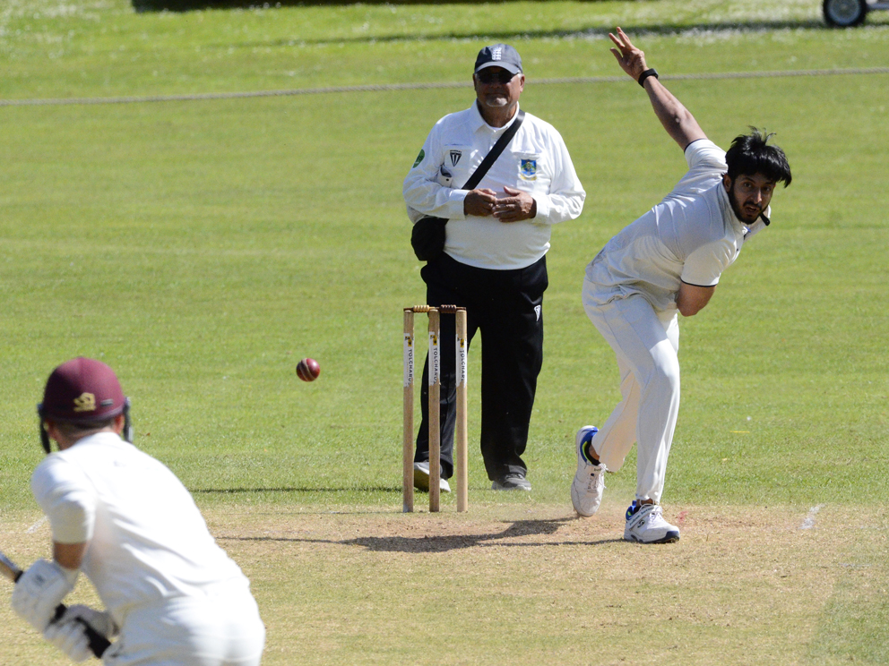 Chudleigh's Darshan_Shivakumar runs in to bowl at Ipplepen opener Marcus Gadie